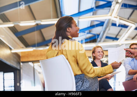Business people with paperwork in meeting Stock Photo