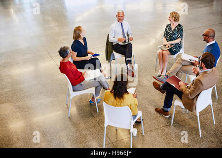Business people talking in meeting circle Stock Photo