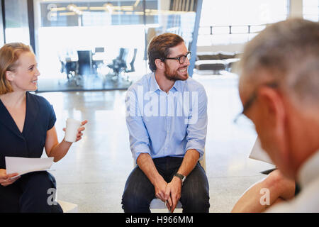 Business people smiling and listening in meeting Stock Photo