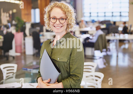Portrait smiling businesswoman in office Stock Photo