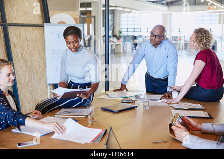 Business people discussing paperwork in conference room meeting Stock Photo