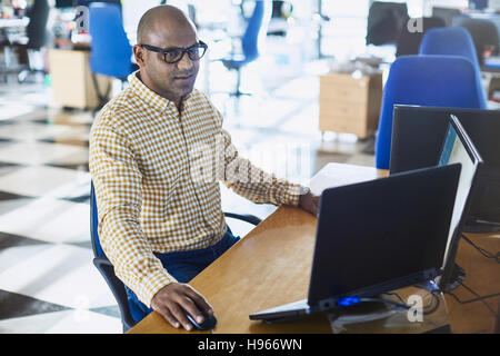 Businessman working at laptop and computer in office Stock Photo