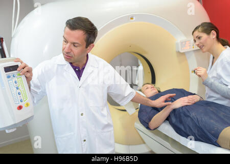 professional with patient and doctor using cat scan Stock Photo