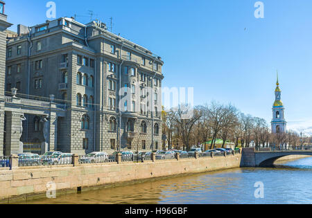 The gray building of Lendoc Art Center, with the tall bell tower of the Sailors' Cathedral on the background, St Petersburg, Russia. Stock Photo