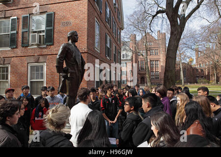 Prospective students take a tour of Yale University Campus. They gather beside the statue of Nathan Hale in front of Connecticut Hall. Stock Photo