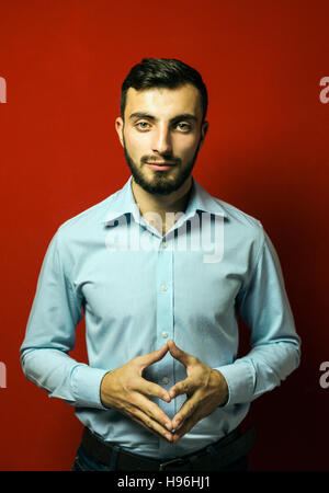Portrait of Young Beard Man on Red Stock Photo