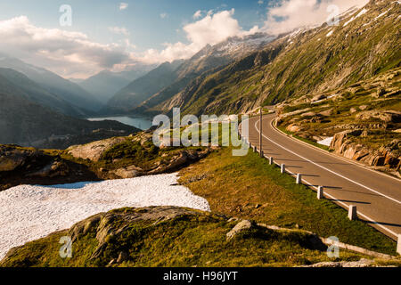 Summer view of Grimselpass with road, Alps and Raterichsbodensee Stock Photo