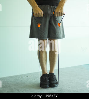 Performing exercises with resistance rope fitness Stock Photo