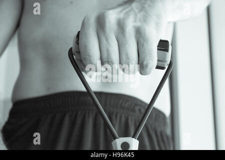 Performing exercises with resistance rope fitness Stock Photo