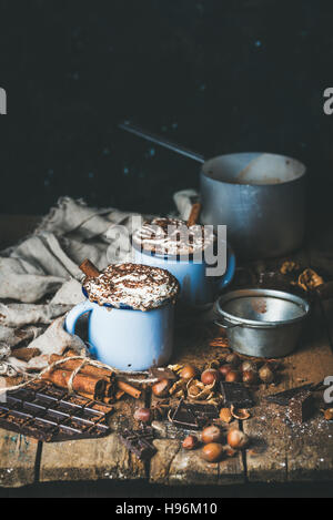 Hot chocolate with whipped cream, different nuts and spices Stock Photo