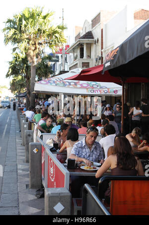 People sitting in and in front of a beach cafe in St. Kilda, a suburb of Melbourne, Victoria, Australia Stock Photo