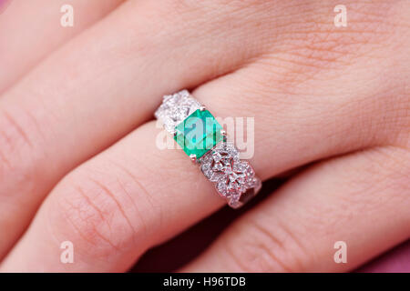 Beautiful luxury ring with gem emerald stone Stock Photo
