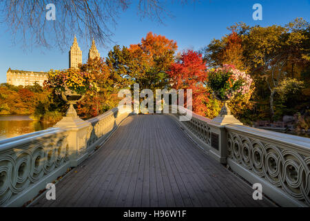 Fall in Central Park at The Lake with the Bow Bridge. Sunrise view with colorful autumn foliage. Upper West Side, New York City Stock Photo