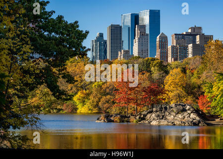 Fall in Central Park at The Lake. Cityscape sunrise view with colorful Autumn foliage on the Upper West Side. New York City