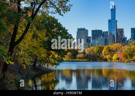 Autumn in Central Park at The Lake with Midtown skyscrapers. Cityscape sunrise view, Manhattan, New York City Stock Photo