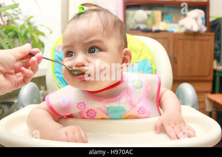 baby girl feeding spoon Stock Photo