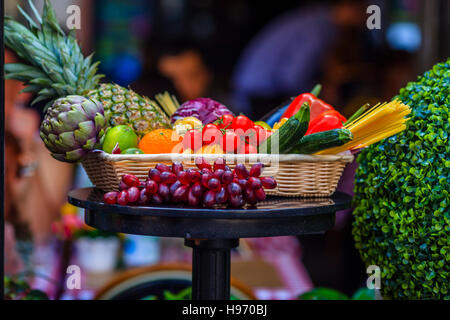 Fresh fruits and vegetables in wicker basket Stock Photo