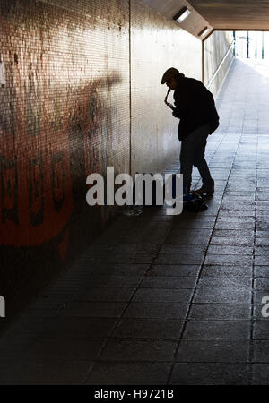 A busker performing in a subway in Truro,Cornwall Stock Photo