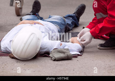 First aid training. Workplace accident. Paramedic in action. Stock Photo
