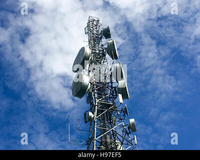 Common communication tower, cellphone tower against blue sky and clouds in Forbes, Tawau, Malaysia. Stock Photo