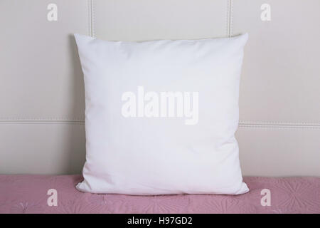 Pillow case Mockup. White pillow on bed in the bedroom. Front view. Stock Photo