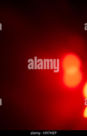 Polygonal red colored light beams in center of solid black background with copy space Stock Photo