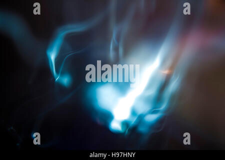 Glowing hazy light in blue and violet colored cloudy background with copy space for concept about something ethereal Stock Photo