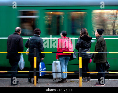 Belgrade, Serbia - November 18, 2016: Tram arriving at a tram stop and people waiting to board, motion blur Stock Photo