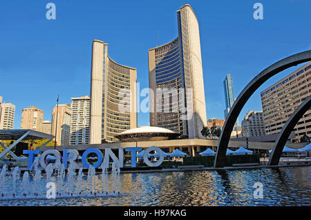 The new City hall of Toronto with the pool in front of it on the Nathan Phillips square and the fountain. Stock Photo