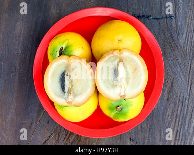 Fresh Abiu or Pouteria caimito fruits on the top of the wooden table with natural light. Stock Photo