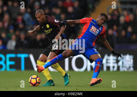 Manchester City's Fernandinho (left) and Crystal Palace's Wilfried Zaha battle for the ball during the Premier League match at Selhurst Park, London. Stock Photo