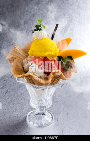 Strawberry and mango ice cream sundae on white background Stock Photo