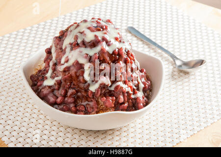 Traditional Japanese Dessert , A Bowl of Red Bean Sweet with red ice on wood pattern Stock Photo