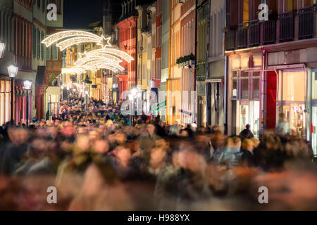 Large crowd of people hustling and shopping in a pedestrian area in Heidelberg, Germany, for Christmas Stock Photo