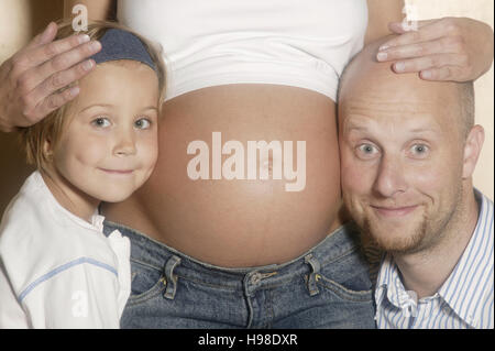 Little girl, pregnant woman, man Stock Photo