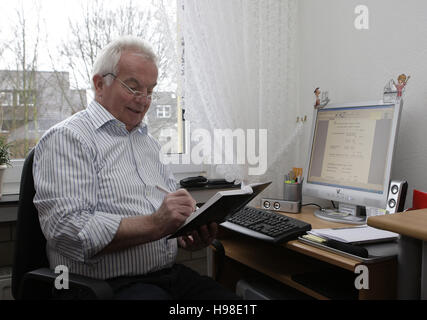 Pensioner using a computer Stock Photo