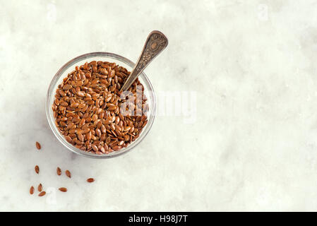 Flax seeds in bowl on stone background with copy space - organic ingredient for healthy vegetarian vegan nutrition Stock Photo