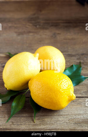 Fresh organic lemons on rustic wooden background with copy space Stock Photo
