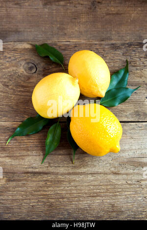Fresh organic lemons on rustic wooden background with copy space Stock Photo