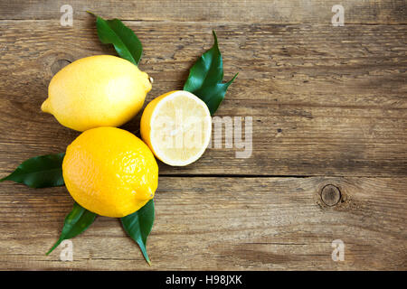 Fresh organic lemons on rustic wooden background with copy space Stock Photo