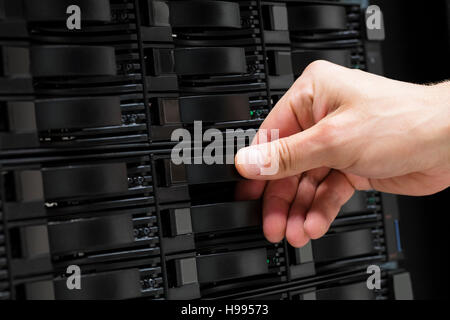 Male Technician's Hand Replacing Hard Drive In San Stock Photo