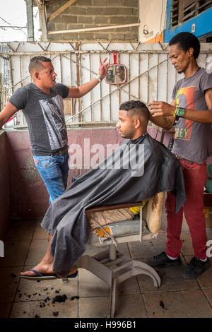 Havana, Cuba: Street barber in the Regla neighborhood of Havana Stock Photo