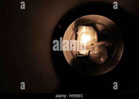 A lightbulb in the dark Stock Photo