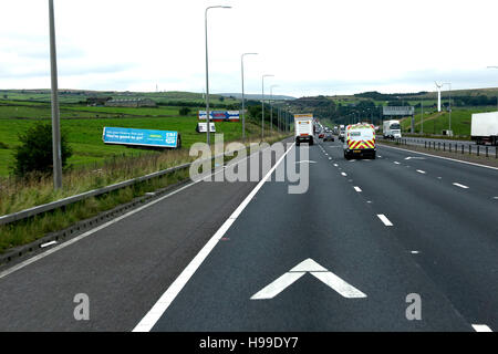 View from inside lane of UK motorway, showing vehicle distance chevron markers. Stock Photo