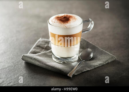 Glass of hot Latte macchiato coffee close up. Stock Photo
