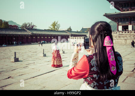 Seoul, South Korea - October 20, 2016: Young girls in traditional dresses at Gyeongbokgung Palace of Seoul, South Korea. Stock Photo