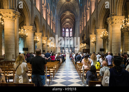 Unidentified tourists visiting the Notre Dame de Paris in Paris, France. The cathedral of Notre Dame is one of the top t Stock Photo