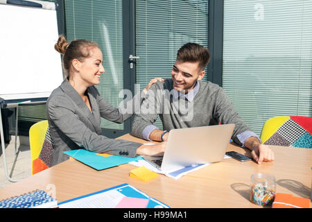 Business people surfing the net in workshop Stock Photo