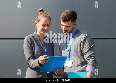 Two business colleagues talking over document Stock Photo