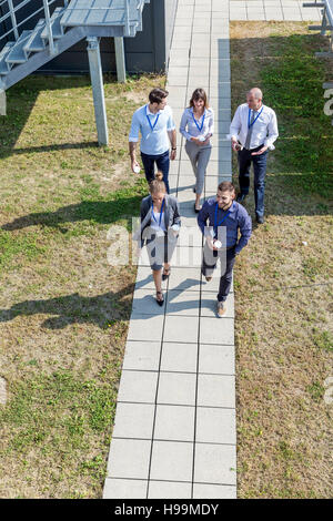 Group of business people taking a coffee break outdoors Stock Photo